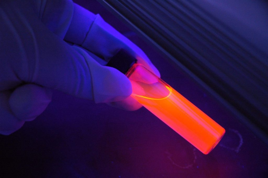 glowing chemical in test tube laboratory